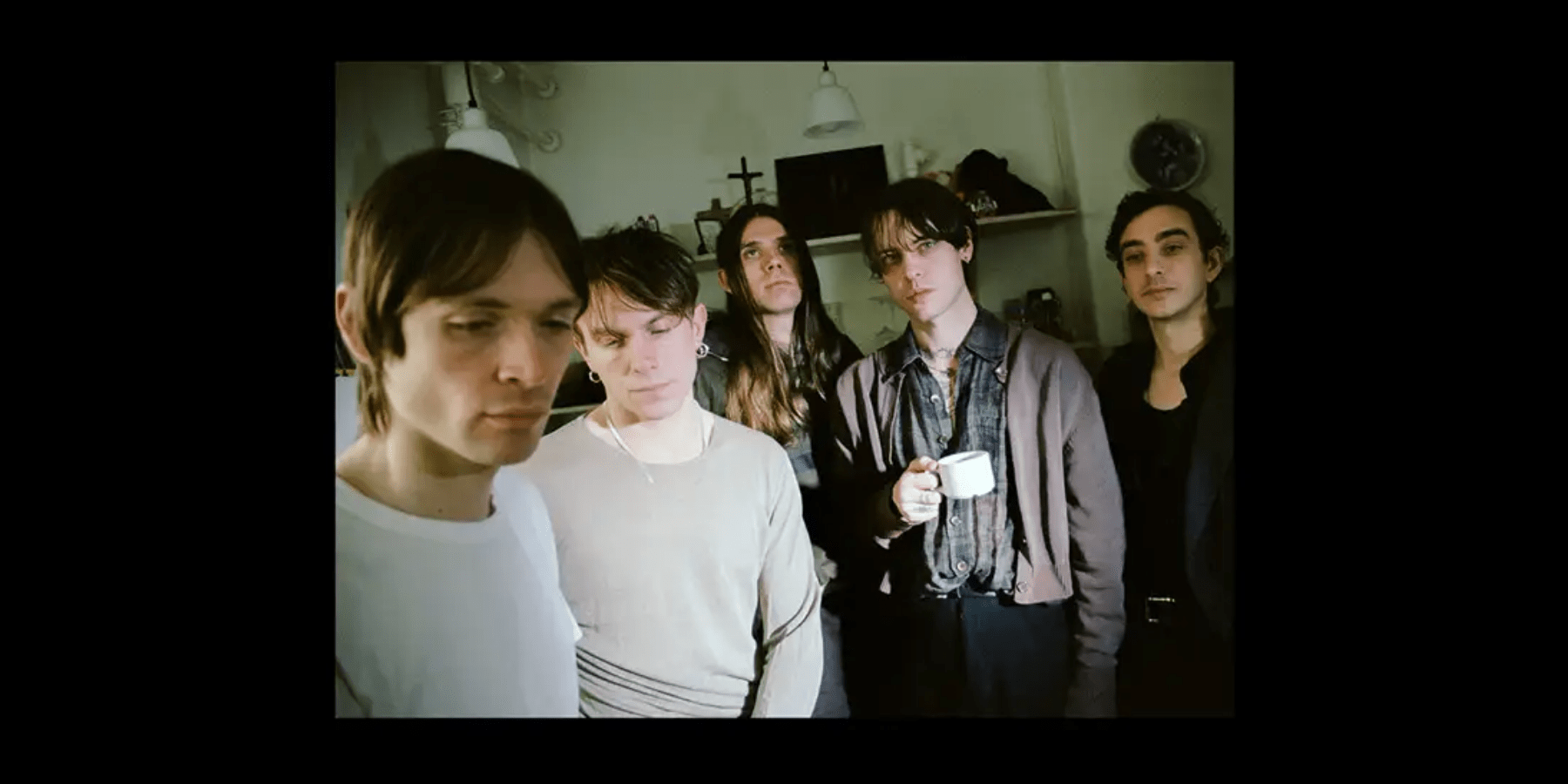 Iceage band members in casual clothing group photo at indoor venue