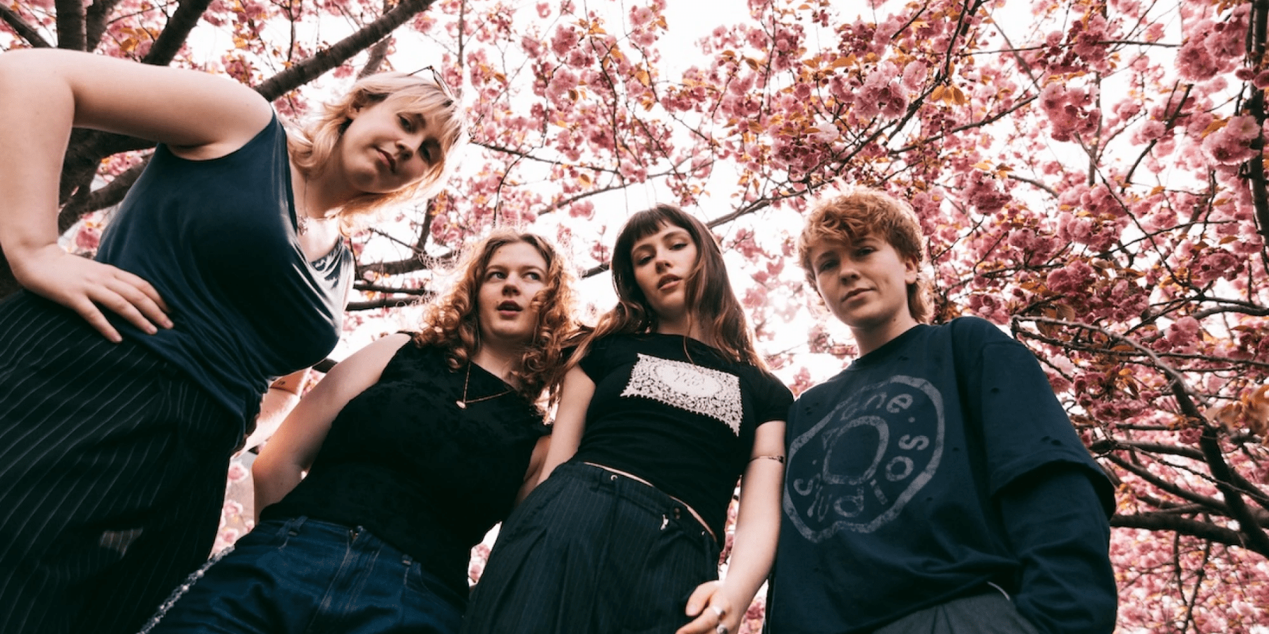 Florence Quigley band group photo under cherry blossom trees in bloom