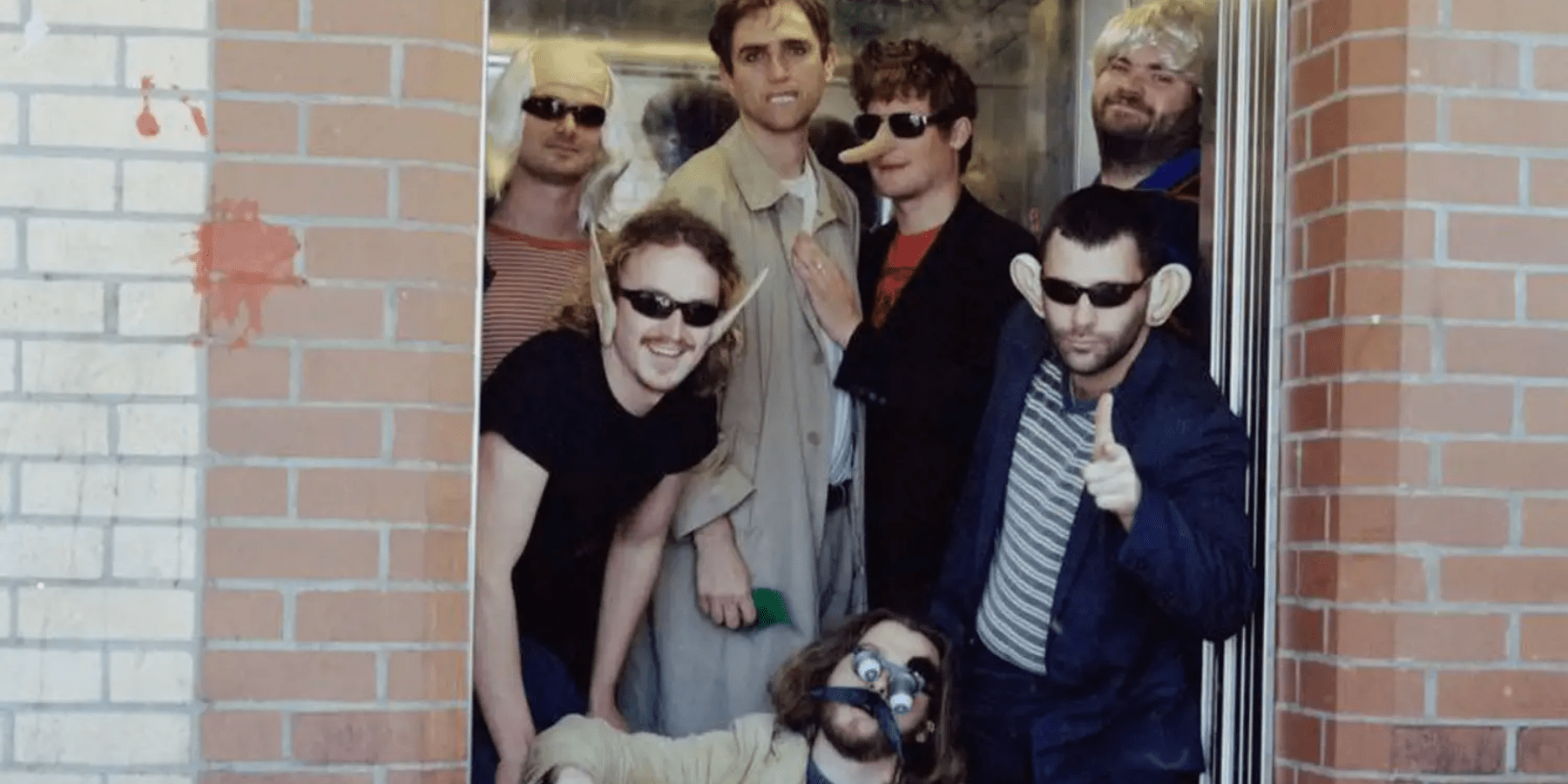 Keg band members in matching outfits wearing sunglasses black and white group photo