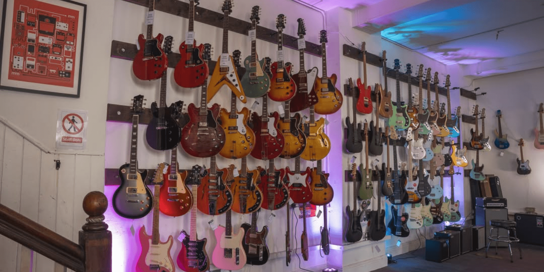 Wall of guitars located in a music shop.